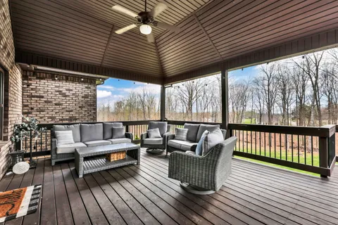 a balcony with furniture and wooden floor