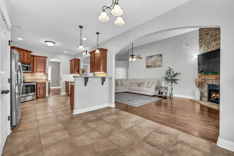 a kitchen with granite countertop a sink a counter space and cabinets