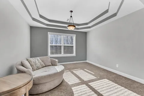 an empty room with a window and a ceiling fan