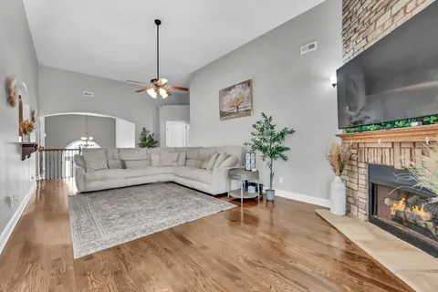 a living room with furniture and a fireplace
