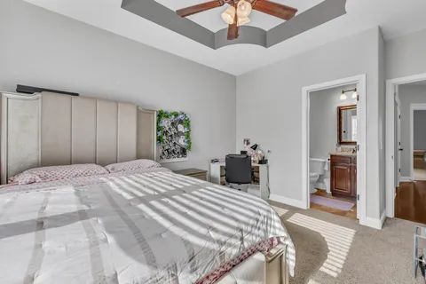 a bedroom with a bed and a ceiling fan
