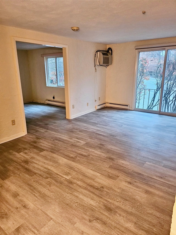 220 Swanson Road, Unit 606 Boxborough, MA 01719 - Photo 6 of 11 an empty room with wooden floor and windows