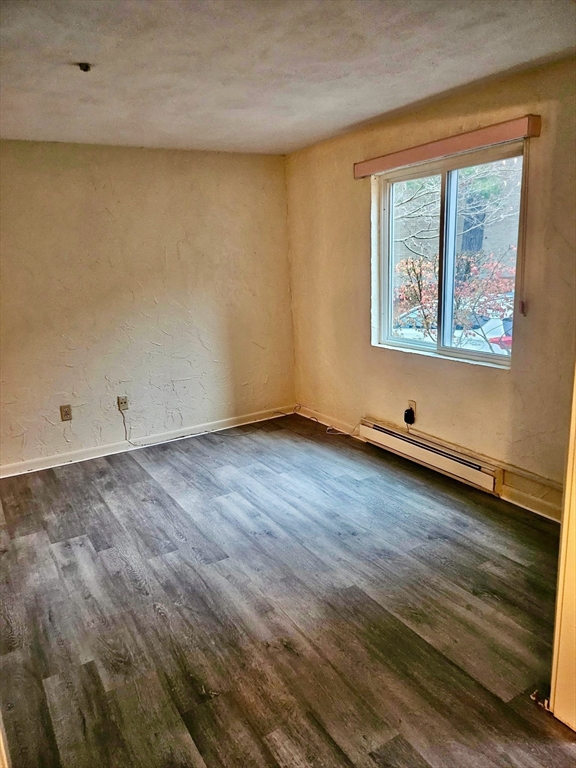220 Swanson Road, Unit 606 Boxborough, MA 01719 - Photo 8 of 11 an empty room with wooden floor and window