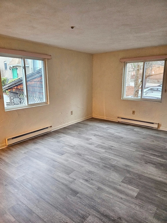 220 Swanson Road, Unit 606 Boxborough, MA 01719 - Photo 9 of 11 an empty room with wooden floor and windows