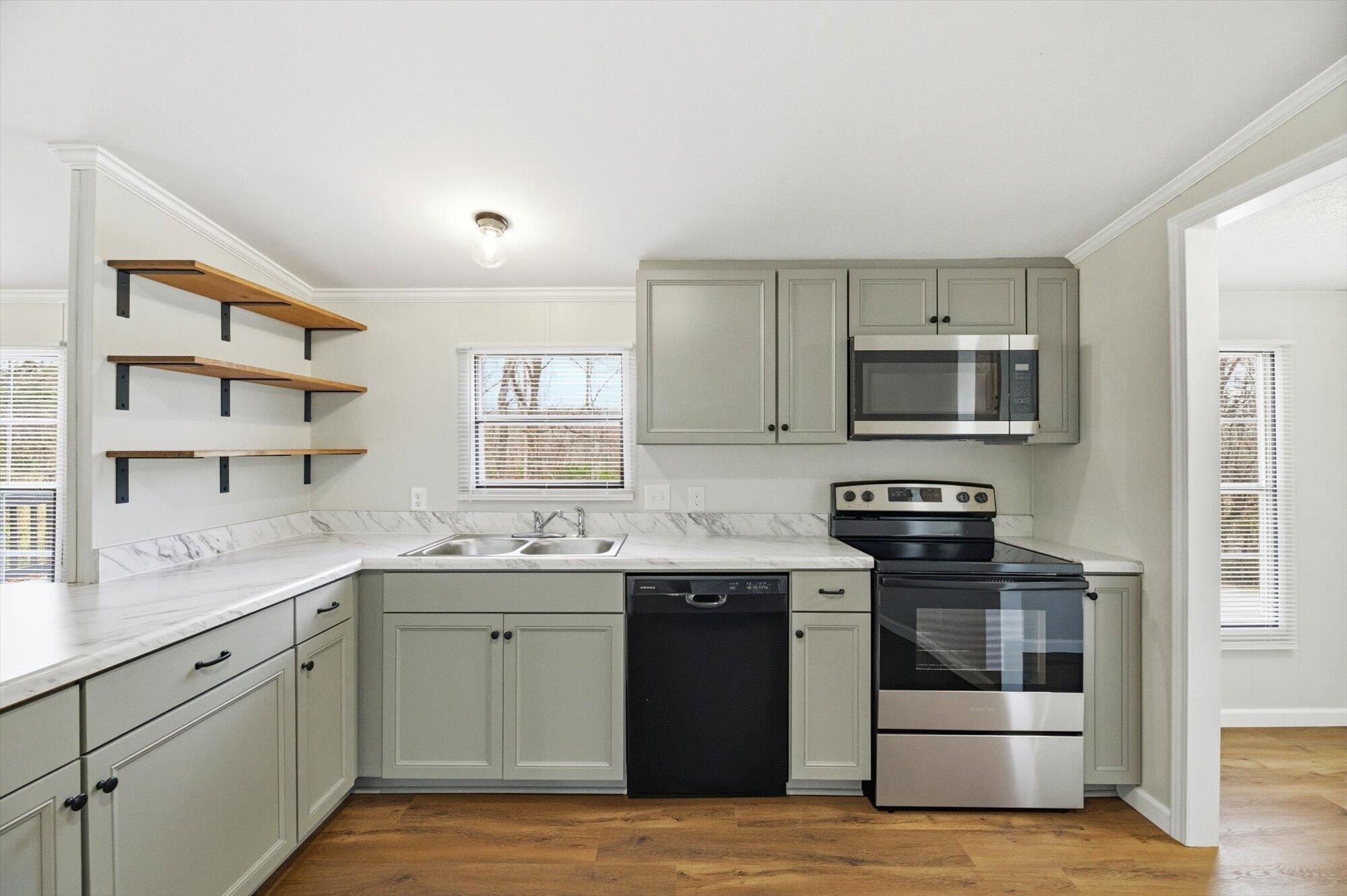 64 County Road 100 Decatur, TN 37322 - Photo 8 of 43 a kitchen with stainless steel appliances granite countertop a sink and stove top oven