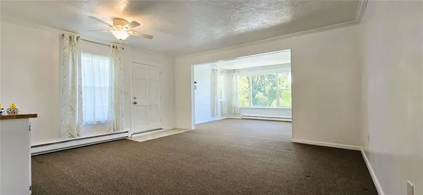an empty room with windows and closet