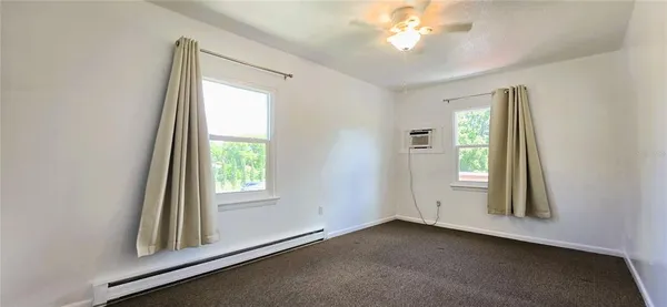 an empty room with windows and closet