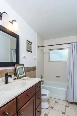 a bathroom with a toilet a sink and bathtub