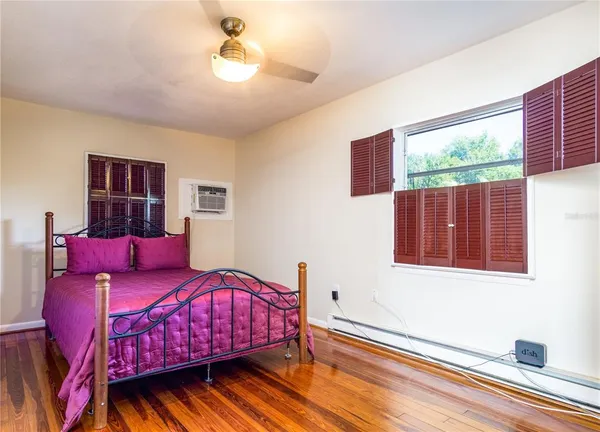 a bedroom with furniture and a window