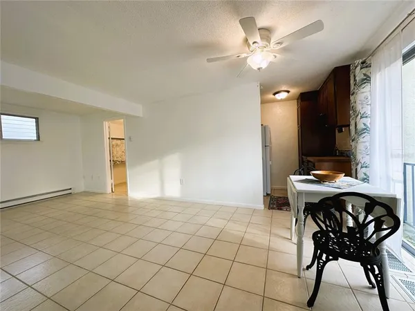 a view of a livingroom with furniture and a chandelier fan