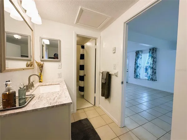a kitchen with stainless steel appliances kitchen island granite countertop a refrigerator and a stove top oven