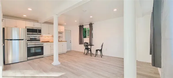 a kitchen with stainless steel appliances granite countertop a refrigerator and a stove top oven