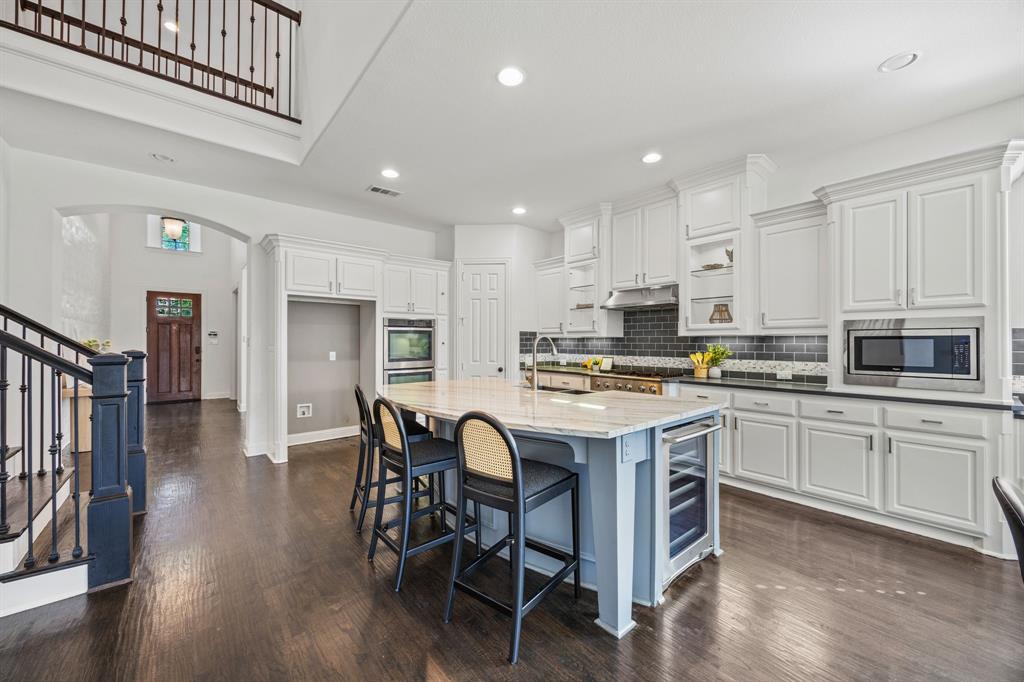 3040 Dunverny The Colony, TX 75056 - Photo 11 of 40 a kitchen with a dining table chairs appliances and cabinets