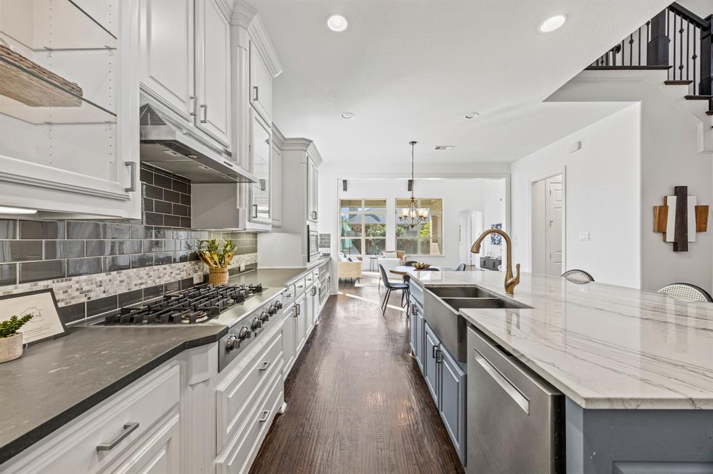 3040 Dunverny The Colony, TX 75056 - Photo 14 of 40 a kitchen with stainless steel appliances a sink stove and cabinets