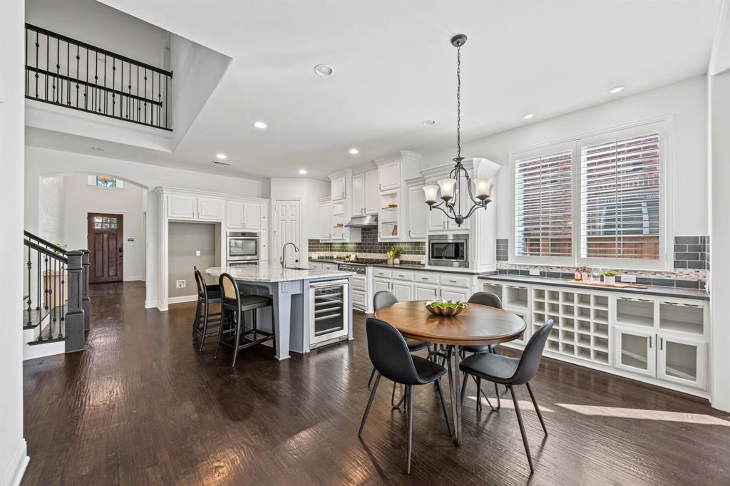 3040 Dunverny The Colony, TX 75056 - Photo 16 of 40 a dining room with furniture a chandelier and wooden floor