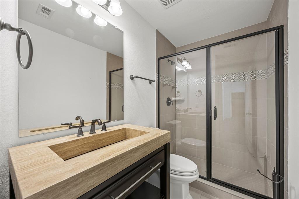 3040 Dunverny The Colony, TX 75056 - Photo 22 of 40 a bathroom with a sink a toilet and shower
