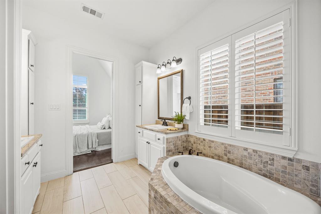 3040 Dunverny The Colony, TX 75056 - Photo 30 of 40 a spacious bathroom with a tub sink and mirror
