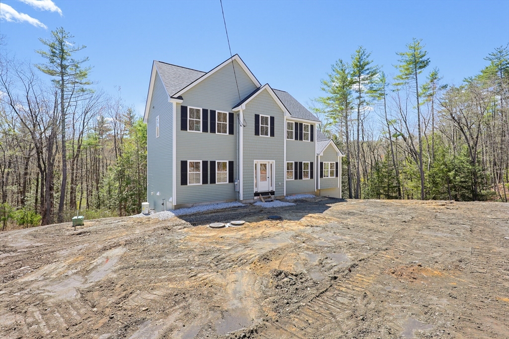 112 West Meadow Road Townsend, MA 01474 - Photo 33 of 38 a front view of a house with a yard and garage