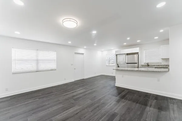 a kitchen with white cabinets and white appliances