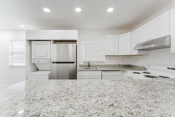 a kitchen with a refrigerator sink and stove