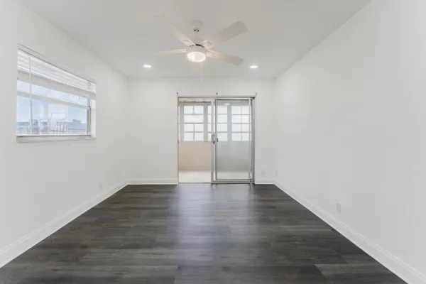 a view of an empty room with wooden floor