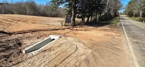 a view of a yard covered with snow on the road