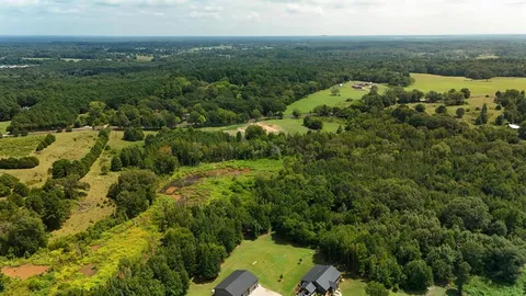 an aerial view of a houses with a yard