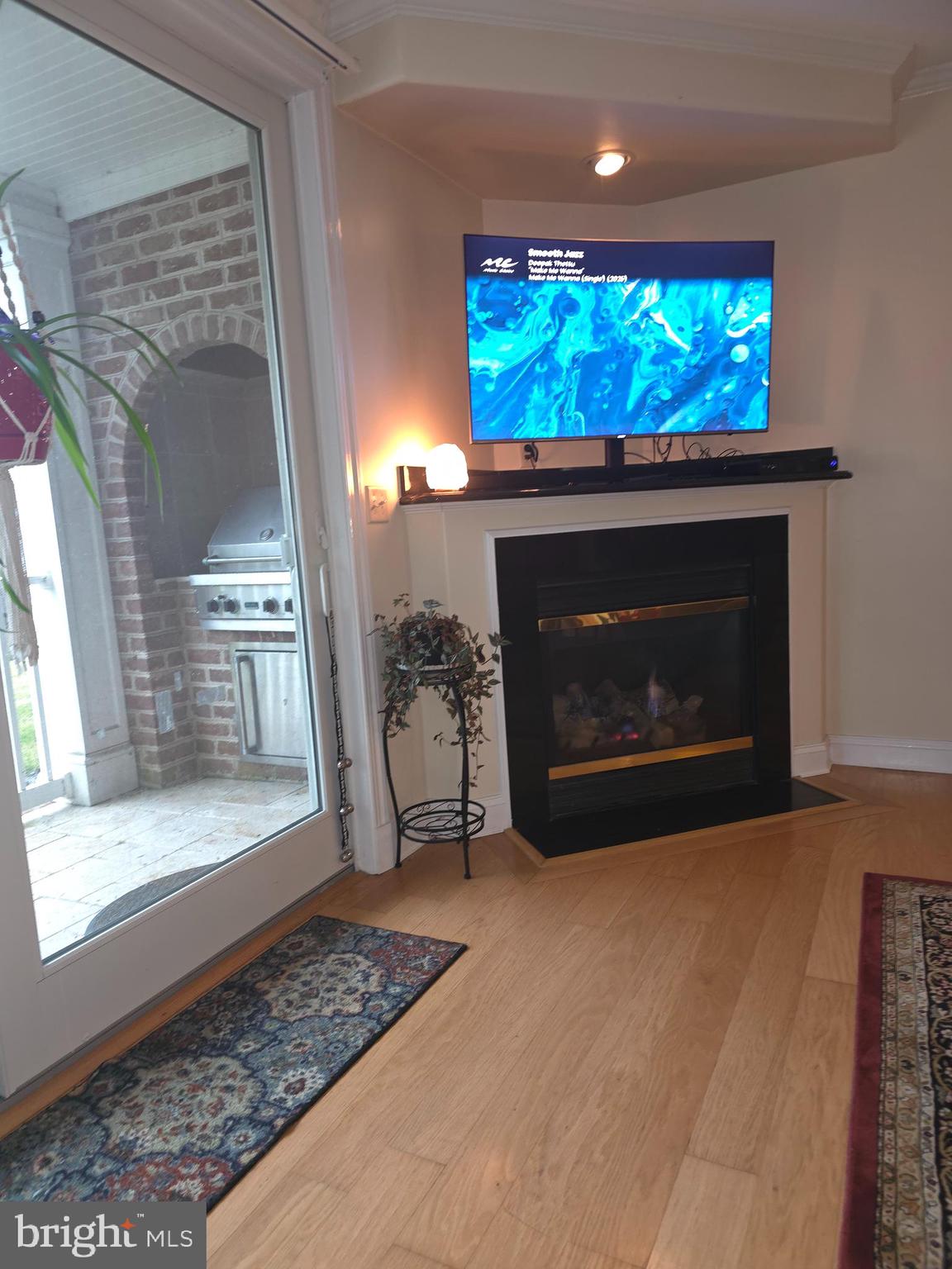 2102 Points Reach, Unit 2102 Berlin, MD 21811 - Photo 15 of 36 a living room with furniture a fireplace and a flat screen tv