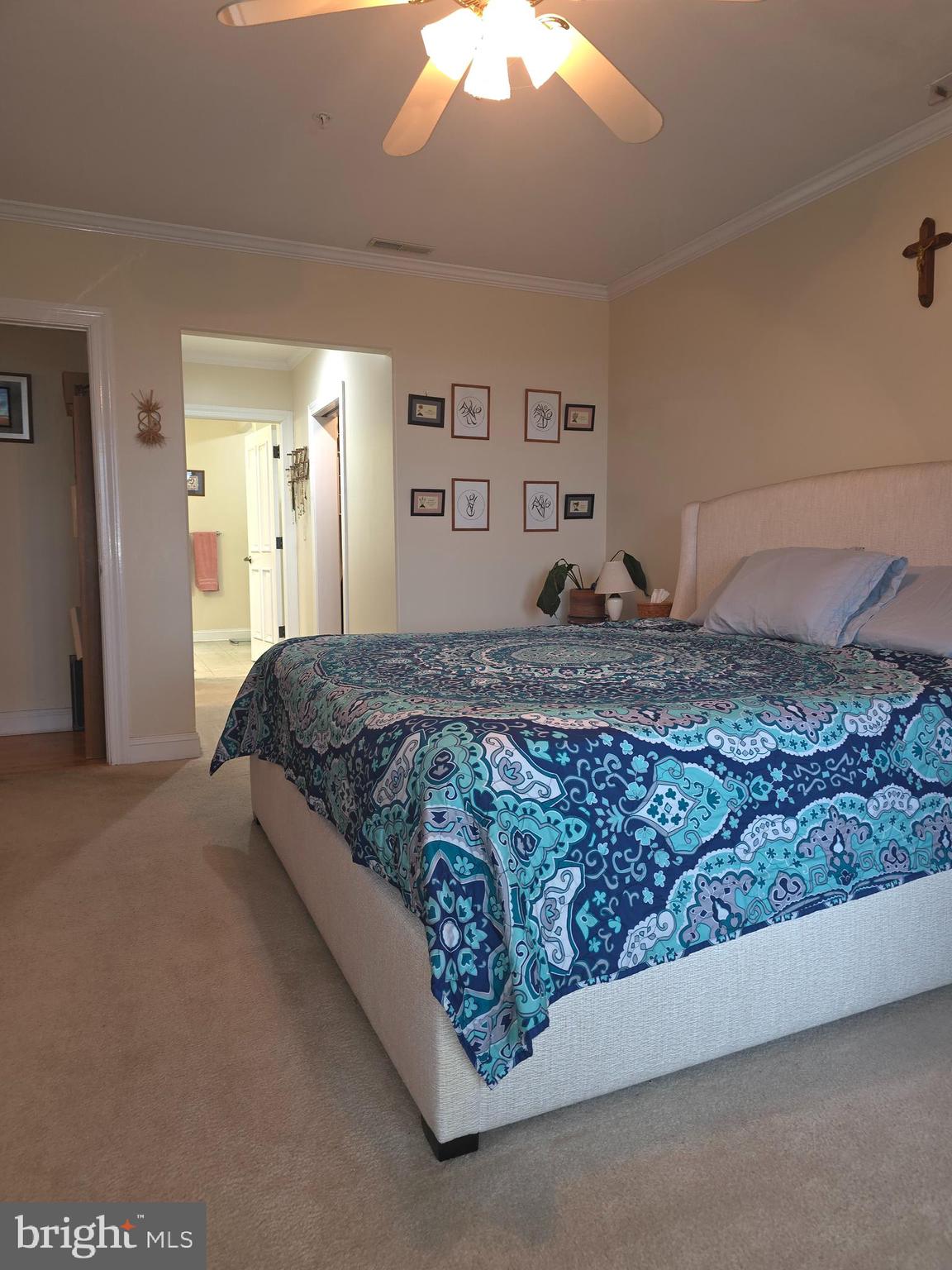 2102 Points Reach, Unit 2102 Berlin, MD 21811 - Photo 19 of 36 a bedroom with a large bed and a chandelier