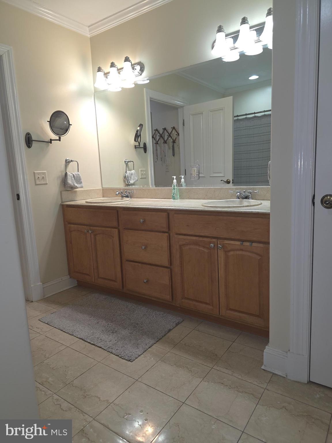 2102 Points Reach, Unit 2102 Berlin, MD 21811 - Photo 23 of 36 a spacious bathroom with a double vanity sink a mirror and a shower