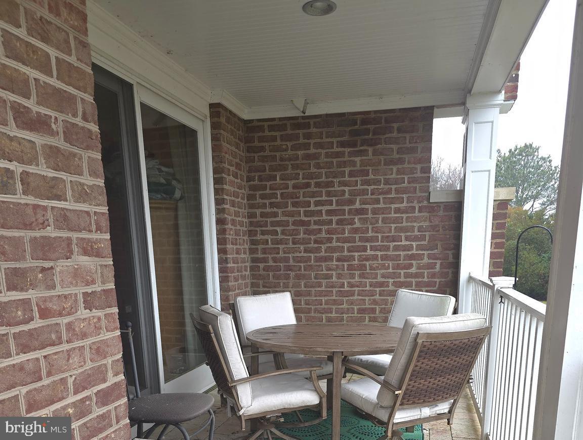 2102 Points Reach, Unit 2102 Berlin, MD 21811 - Photo 30 of 36 a blue chair sitting in front of a door