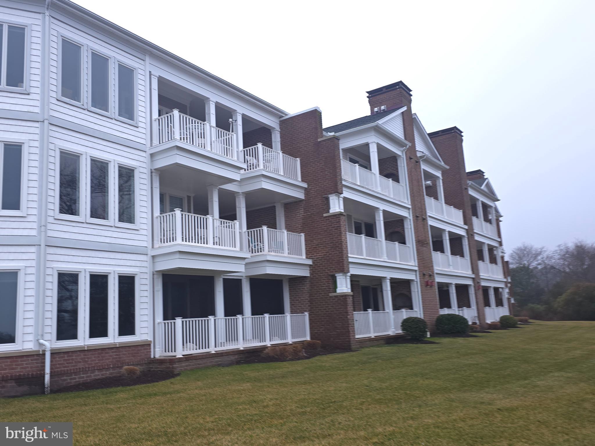 2102 Points Reach, Unit 2102 Berlin, MD 21811 - Photo 33 of 36 a large building with a yard in front