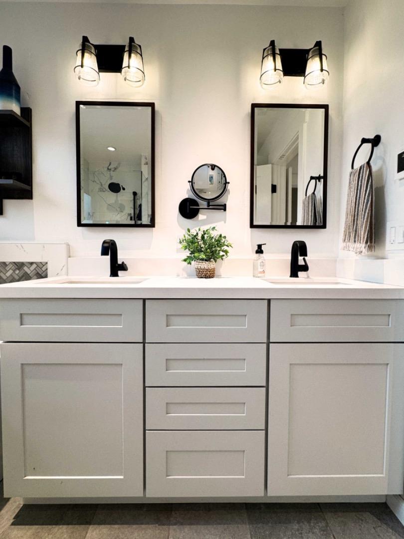 3308 Sycamore Place Carmel, CA 93923 - Photo 10 of 14 a bathroom with double vanity sinks and a mirror