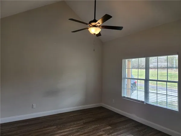 a view of a room with wooden floor and windows