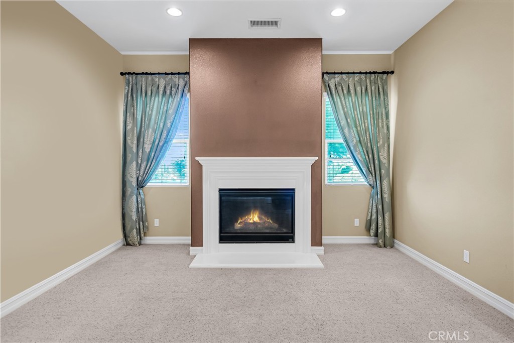 7780 Solitude Court Riverside, CA 92506 - Photo 15 of 63 a view of an empty room with a fireplace and a window