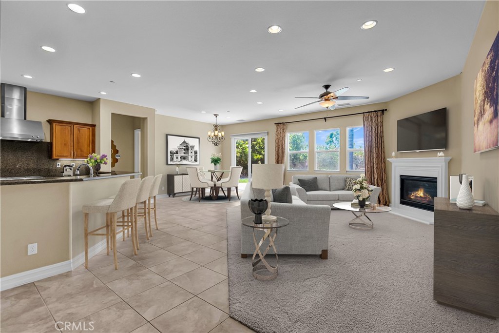 7780 Solitude Court Riverside, CA 92506 - Photo 21 of 63 a living room with furniture a fireplace and a flat screen tv