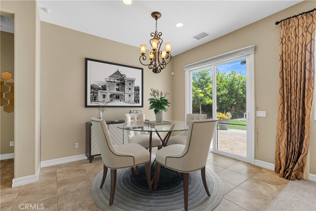 7780 Solitude Court Riverside, CA 92506 - Photo 23 of 63 a view of a dining room with furniture a chandelier and a window