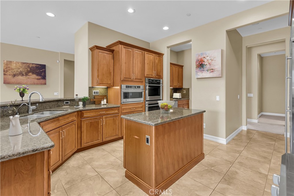 7780 Solitude Court Riverside, CA 92506 - Photo 25 of 63 a kitchen with stainless steel appliances granite countertop a stove a sink and a refrigerator