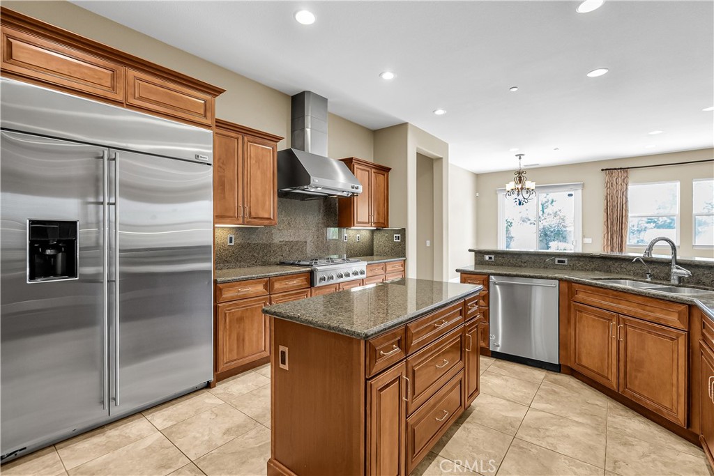 7780 Solitude Court Riverside, CA 92506 - Photo 26 of 63 a kitchen with stainless steel appliances granite countertop a sink stove and refrigerator