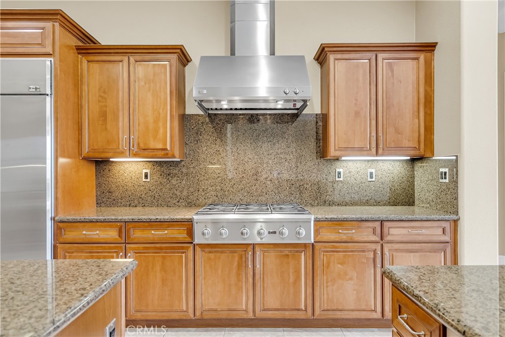 7780 Solitude Court Riverside, CA 92506 - Photo 28 of 63 a kitchen with granite countertop a sink and cabinets