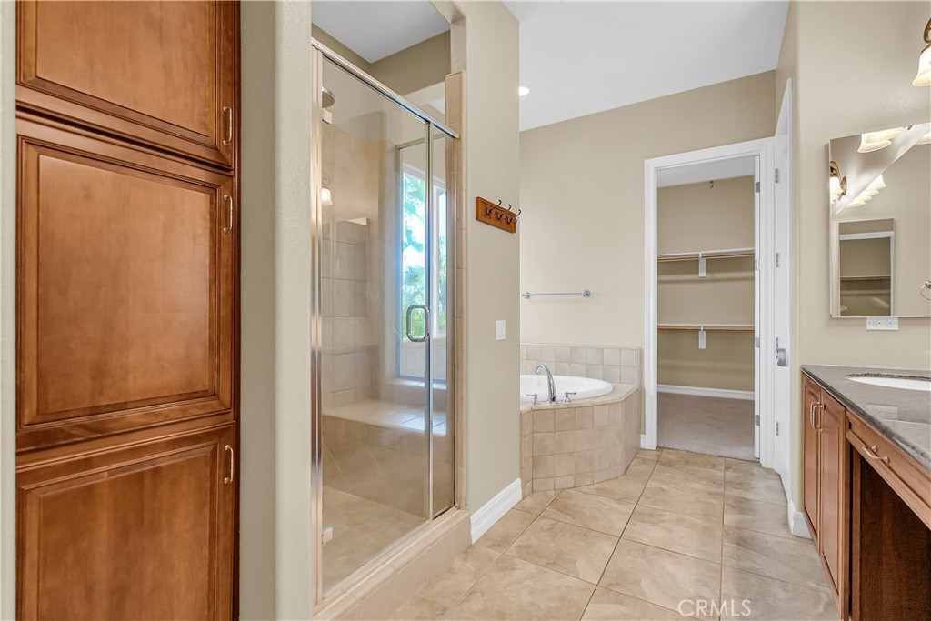 7780 Solitude Court Riverside, CA 92506 - Photo 35 of 63 a bathroom with a granite countertop sink mirror and toilet