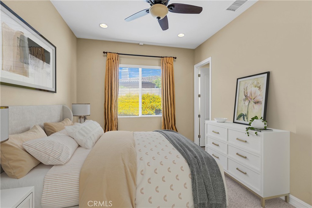 7780 Solitude Court Riverside, CA 92506 - Photo 37 of 63 a bedroom with a bed and a chandelier