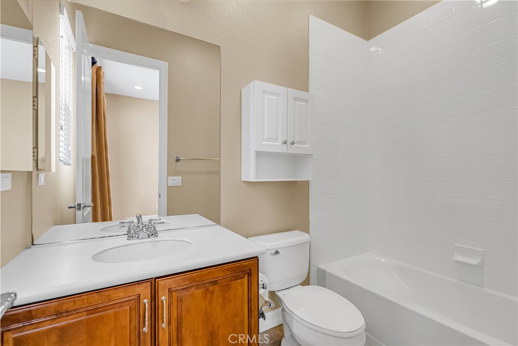 7780 Solitude Court Riverside, CA 92506 - Photo 39 of 63 a bathroom with a granite countertop sink toilet and shower