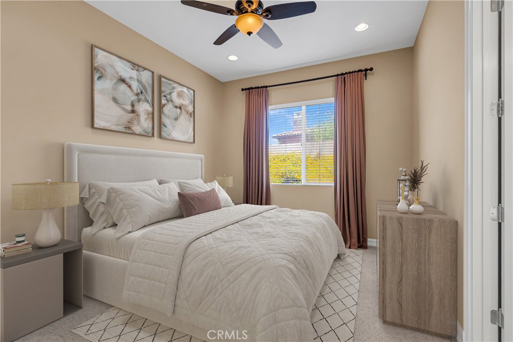 7780 Solitude Court Riverside, CA 92506 - Photo 40 of 63 a bedroom with a large bed and a chandelier