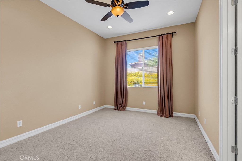 7780 Solitude Court Riverside, CA 92506 - Photo 41 of 63 an empty room with a window and a ceiling fan
