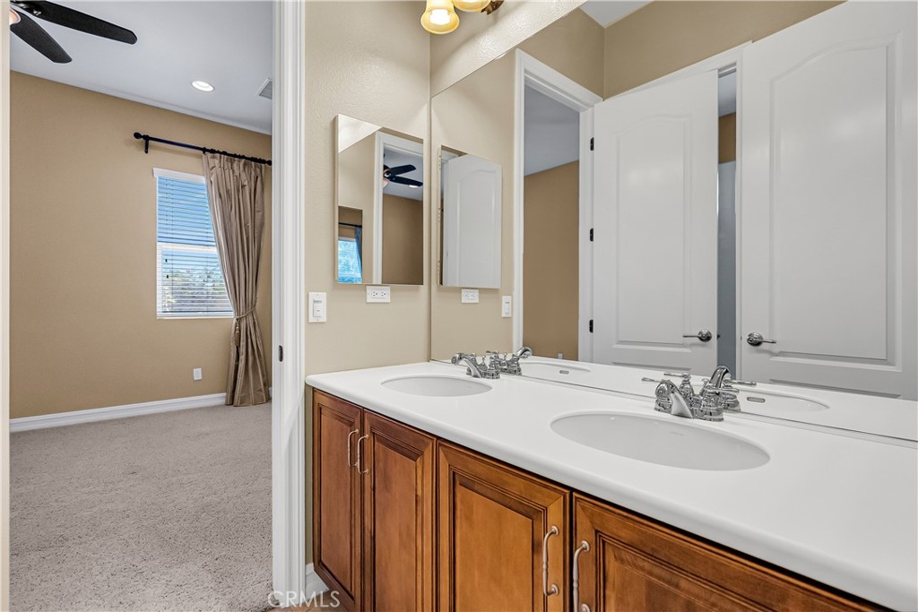 7780 Solitude Court Riverside, CA 92506 - Photo 42 of 63 a bathroom with a sink double vanity and a mirror