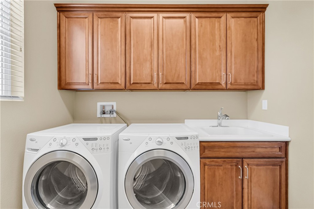 7780 Solitude Court Riverside, CA 92506 - Photo 46 of 63 a utility room with dryer and washer