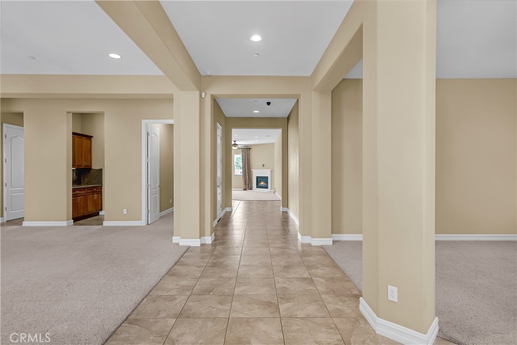 7780 Solitude Court Riverside, CA 92506 - Photo 10 of 63 a view of a hallway with wooden shelves