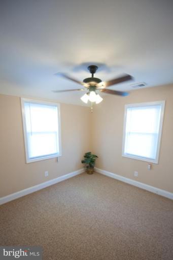 3127 Sollers Point Road Dundalk, MD 21222 - Photo 4 of 14 an empty room with a window and a fan