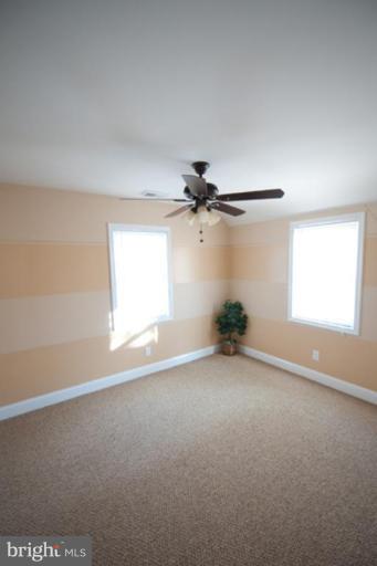3127 Sollers Point Road Dundalk, MD 21222 - Photo 5 of 14 an empty room with windows and fan